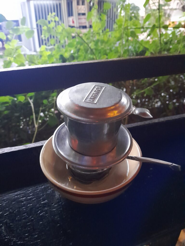 Vietnamese coffee being made with a phin.