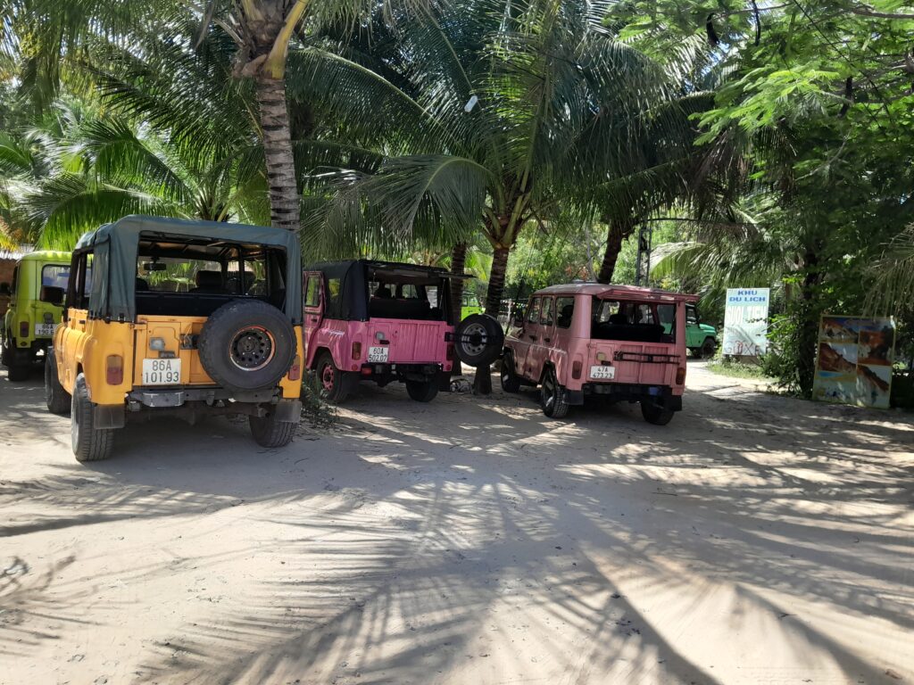 Colourful land rovers that offer tours to visitors.