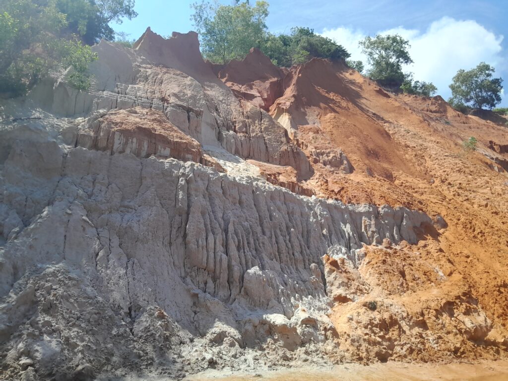 More limestone formations, giving way to red clay cliffs.