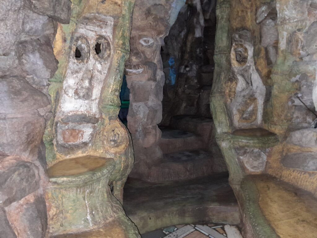 Faces stare at you as you climb the winding stairs.