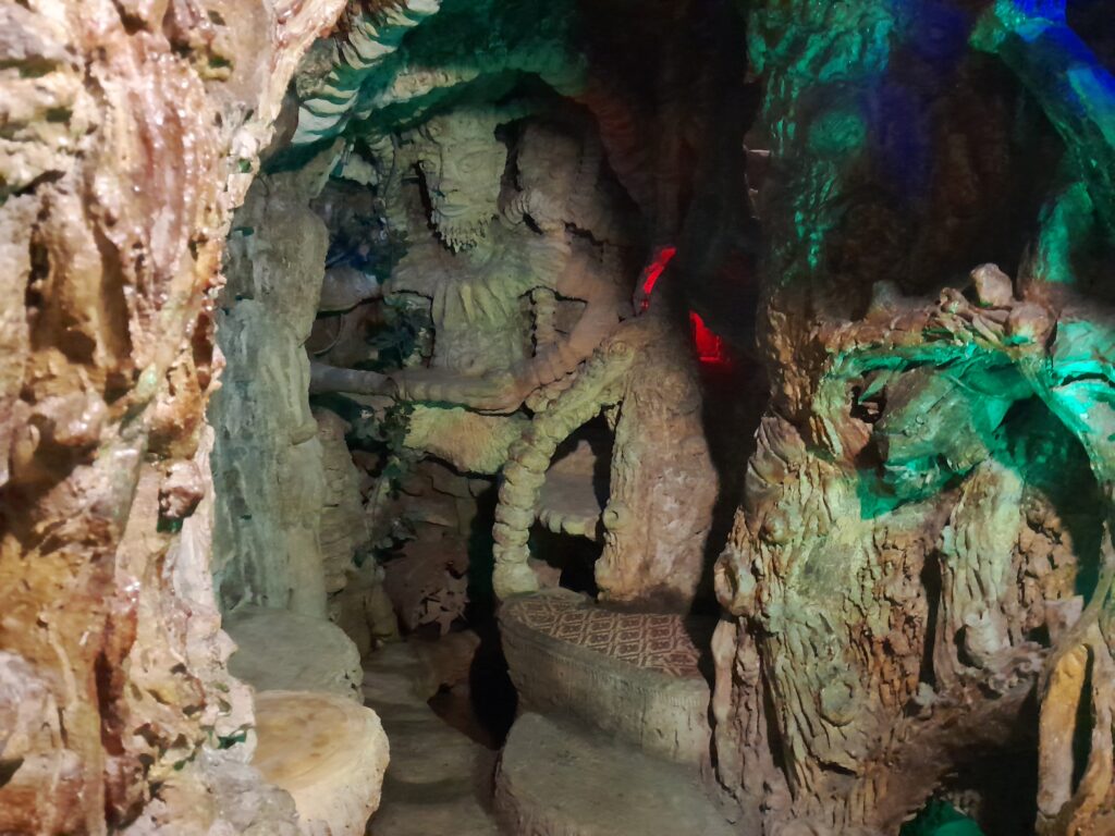 An ancient mask carved into a tunnel.
